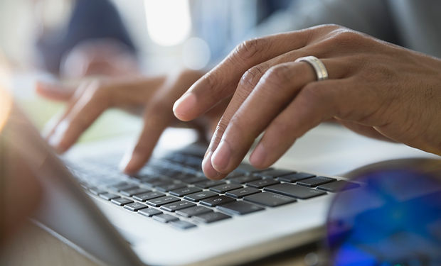 Man Typing on a Laptop