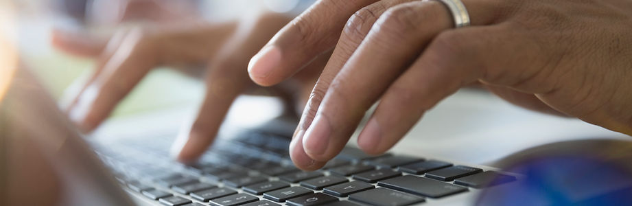 Man Typing on a Laptop