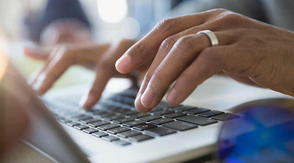 Man Typing on a Laptop