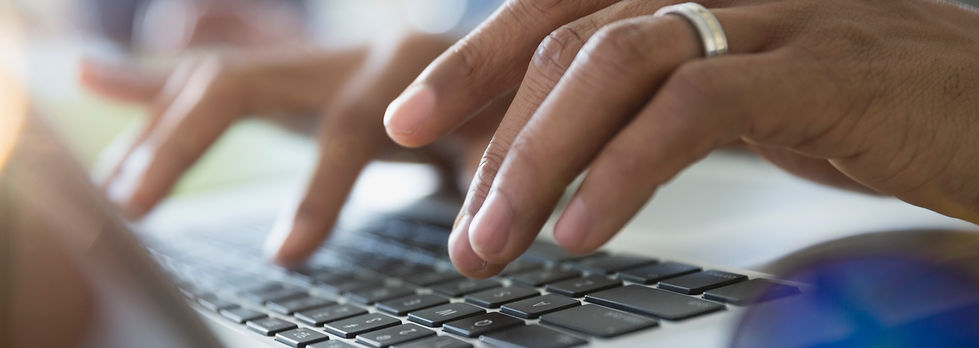 Man Typing on a Laptop