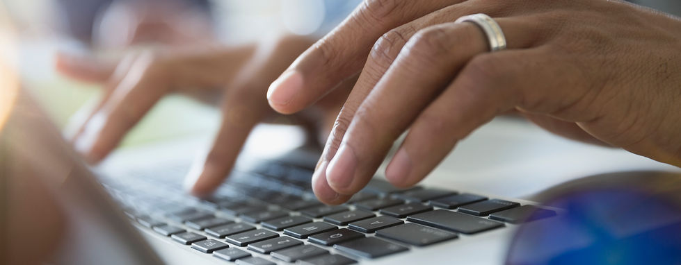 Hands Typing on Laptop