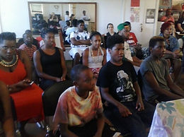 An audience engaged in an open mic experience at Express Yourself Milwaukee Studio Event