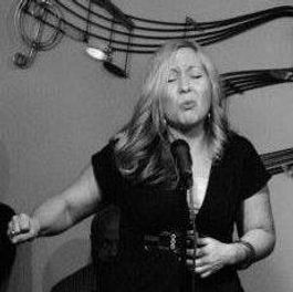 Darlin Nikki Janzen performing with passion at an open mic Poetry Unplugged