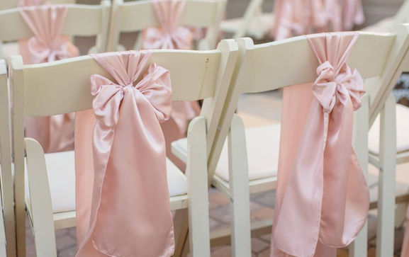 ivory folding wood chairs with blush sashes