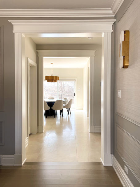 A stunning view from one room to another framed out by beautiful door casings and moulding. Design by Caroline Loon Designs