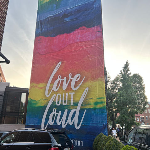 Photo of a rainbow banner on a building