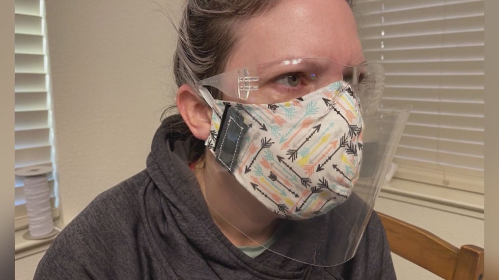 A woman wearing a cloth mask under a face shield with protective goggles