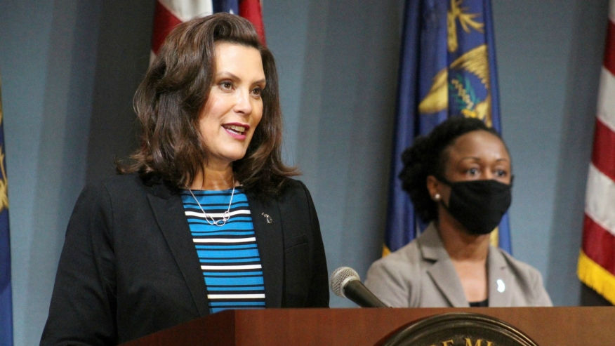 Gretchen Whitmer and an MDHSS official at a press conference