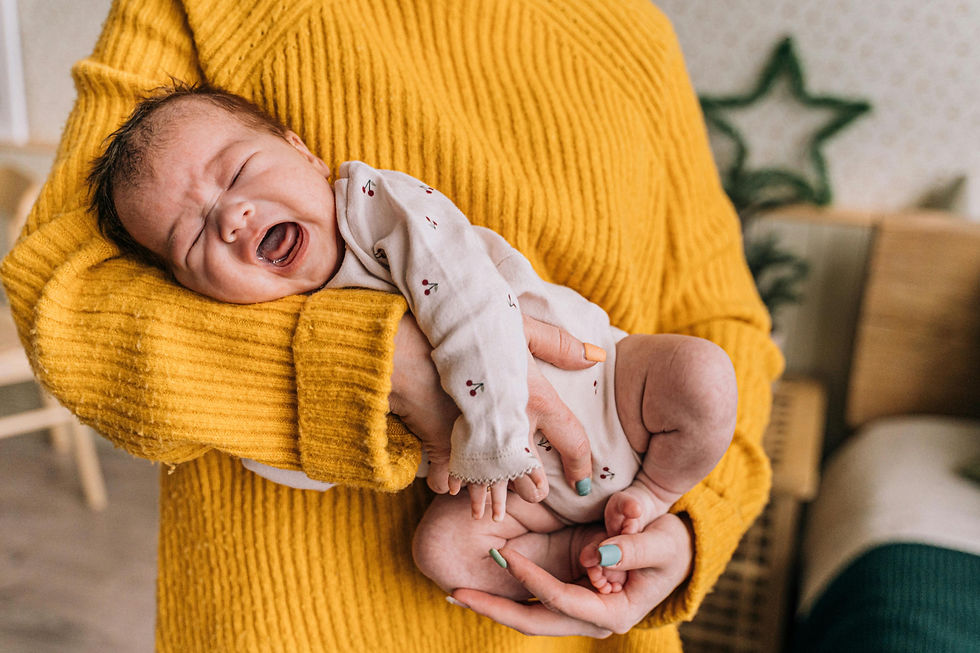 baby in a side hold while crying