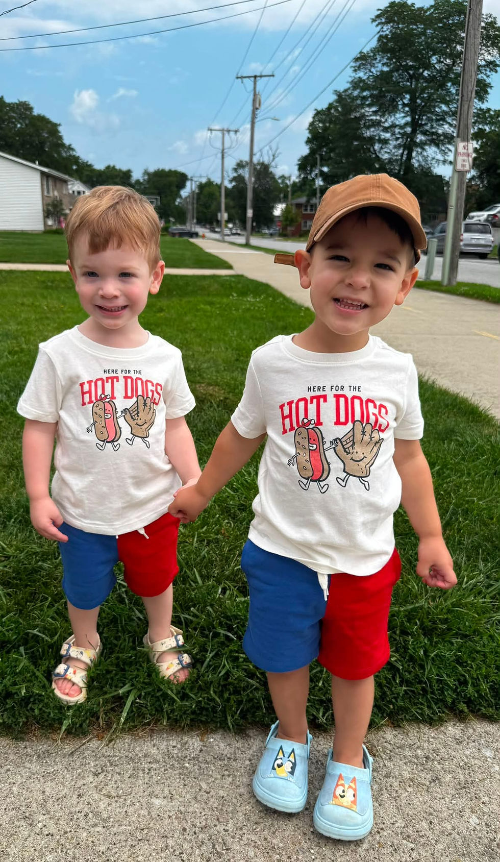 two twin boys holding hands