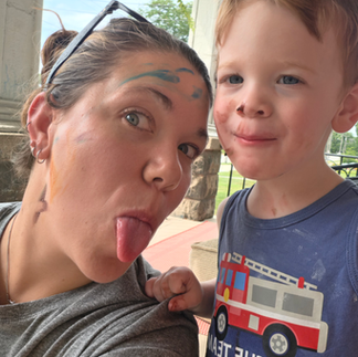 toddler and mom smiling outside