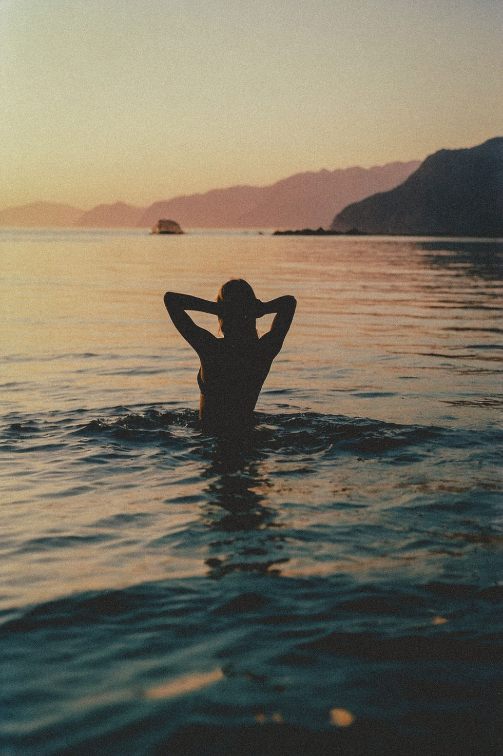 Coastal - Silhouetted figure wading in calm golden sunset waters - TVS.jpg