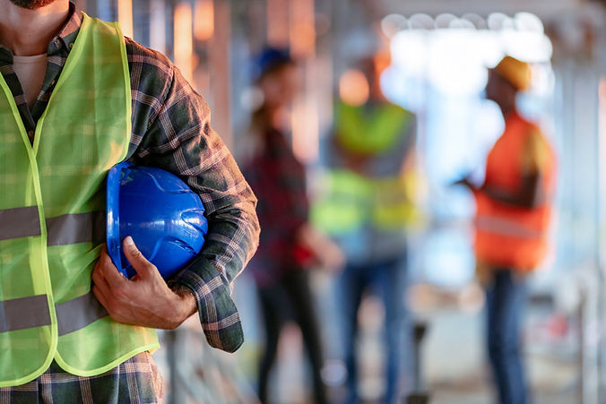 Employee holding his hard hat