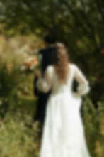 A couple at the wild garden at a wedding at the Barn