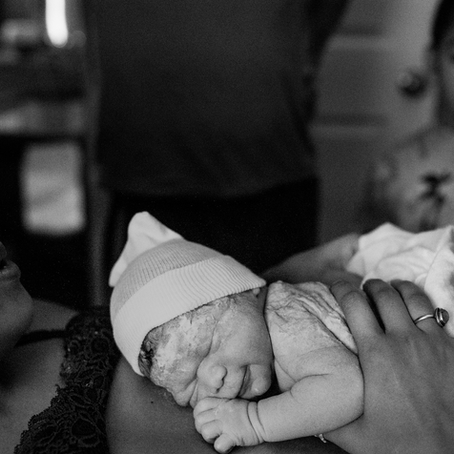 Black and white photo of Johanna holding newborn daughter just after giving birth.