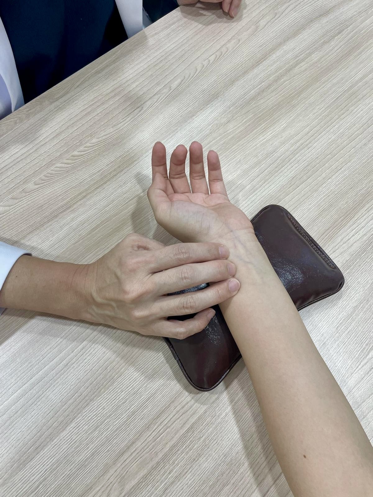 Close-up of a wrist pulse assessment at Olive3 TCM Clinic