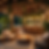 “A tropical outdoor bar with wooden and rattan furniture, warm hanging lanterns, and lush greenery.