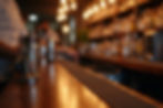 Close-up of bartending tools on a U shaped bar