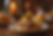 A festive meal with a lit candle on a cake, surrounded by creamy dishes and desserts on a wooden table, creating a cozy, celebratory mood.