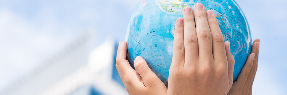 Cropped image of the leaders of the company holding a globe miniature in hands in the sign