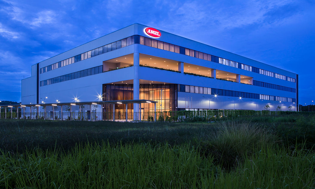 Night exterior view of a corporate manufacturing facility in Singapore.