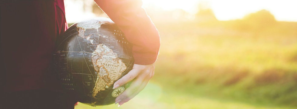 Person holding a globe showing Latin America, symbolising professionals navigating global job interviews in English