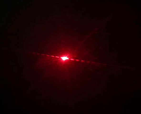 This happens because the light bends around the hair strand, it spreads out instead of going straight, and this bending causes the formation of alternating bright and dark bands.