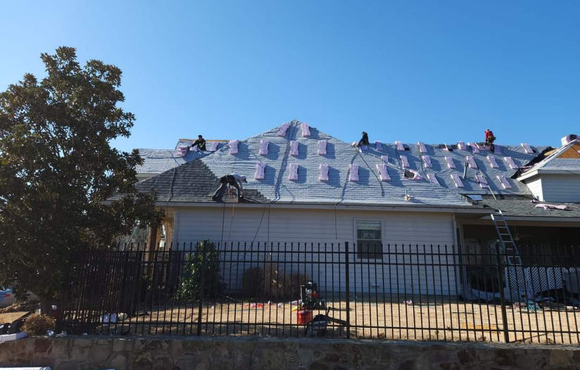 Roofing crew installing new roof