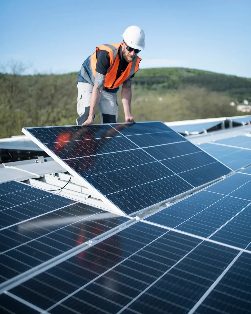 A solar panels for businesses UK installation in process with an engineer.