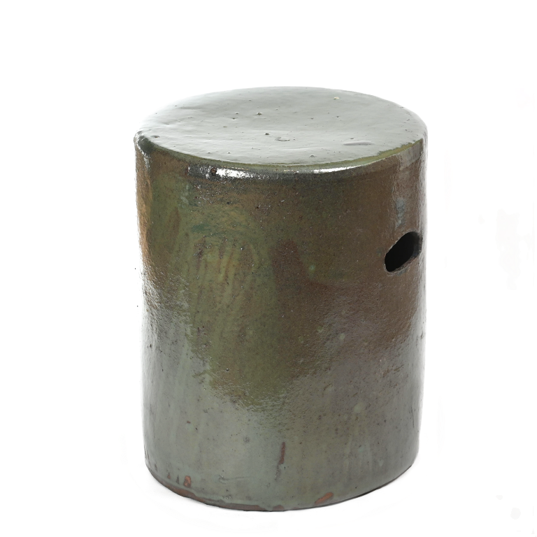 Round ceramic footstool with deep green glazed top and raw base