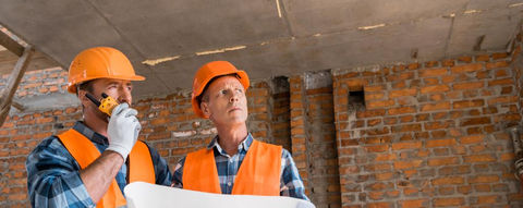 stock-photo-constructor-holding-blueprint-handsome-coworker.jpeg