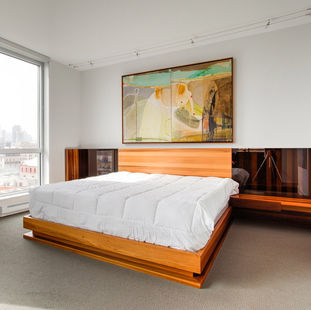 Custom bedroom cabinetry with soft-close drawers and natural veneer finish