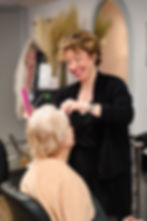 A older woman getting her hair cut by a professional