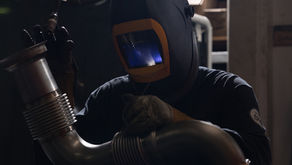 Auto-jet welder joining a flanged stainless exhaust pipe