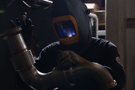 Auto-jet welder joining a flanged stainless exhaust pipe