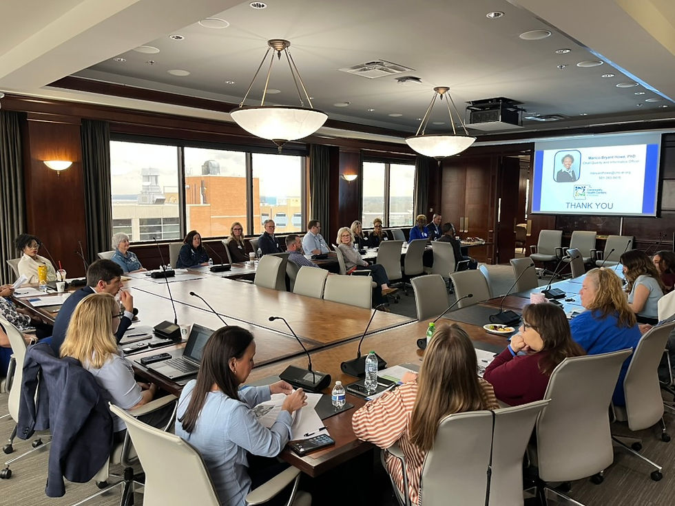 A room full of people watching a presentation. 