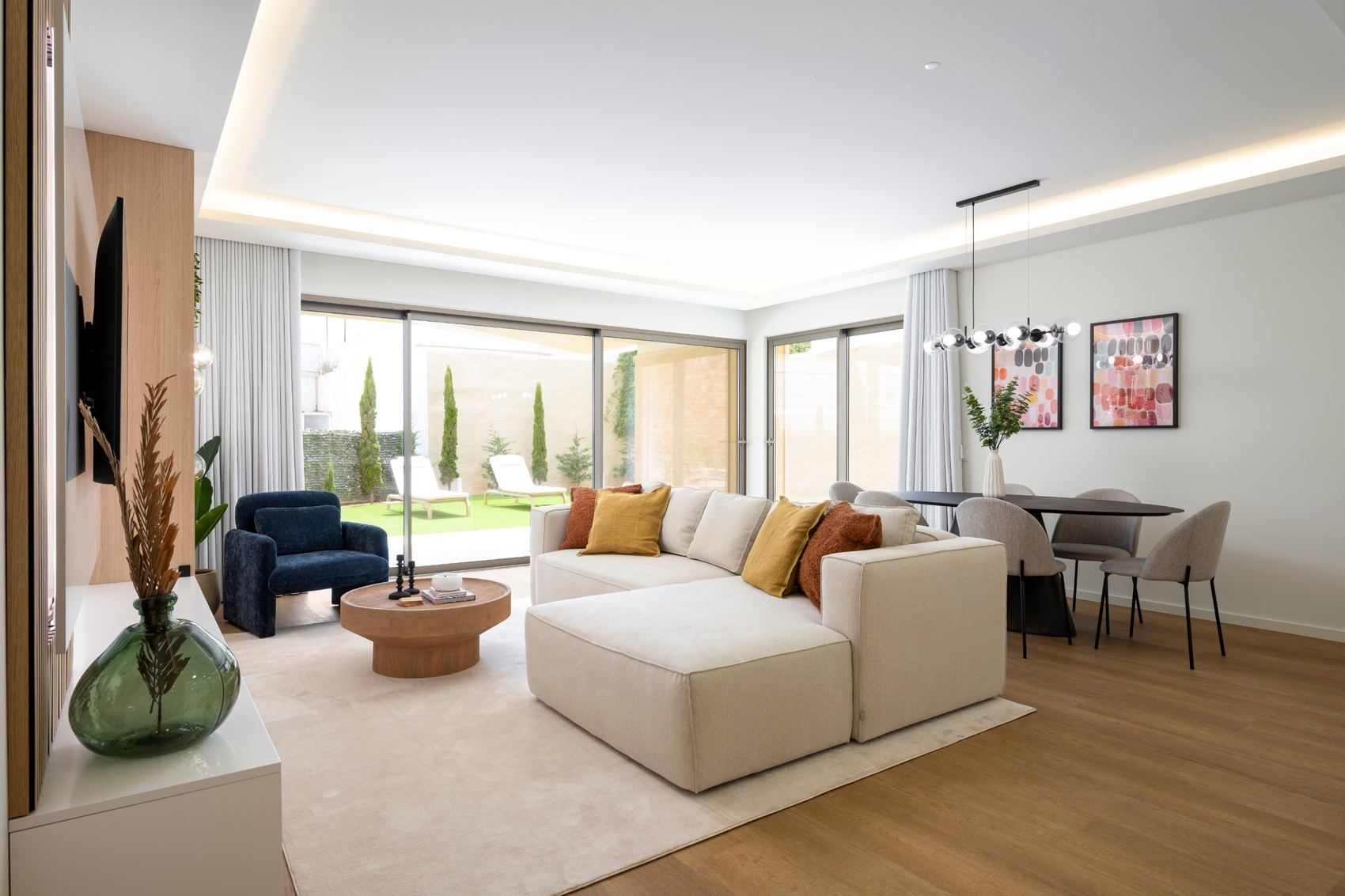 Sala mobilada e pronta, com os vãos abertos para o jardim