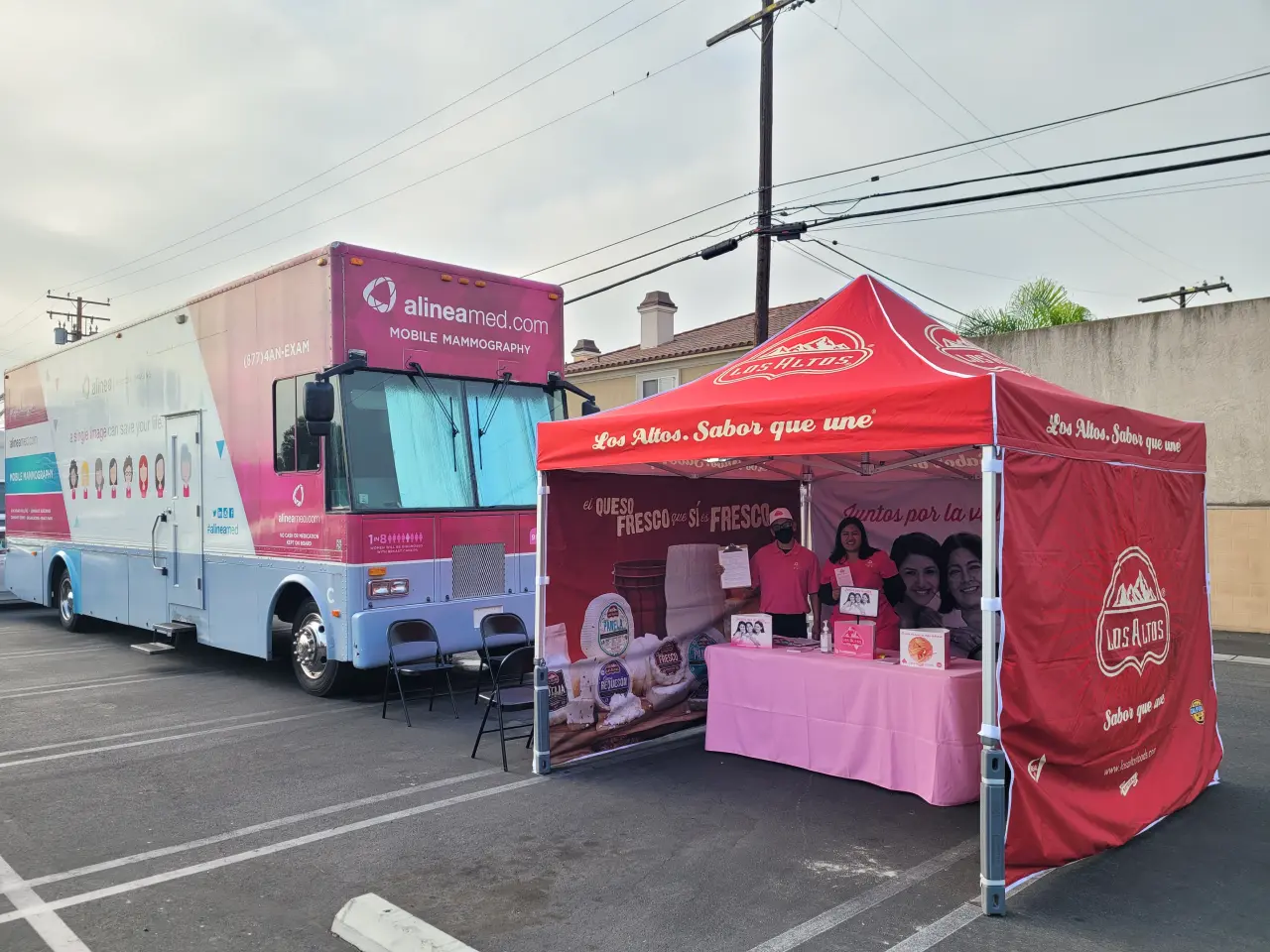 Heavy duty custom pop up tent with Los Altos graphics next to a large mobile mammography truck in a parking lot.