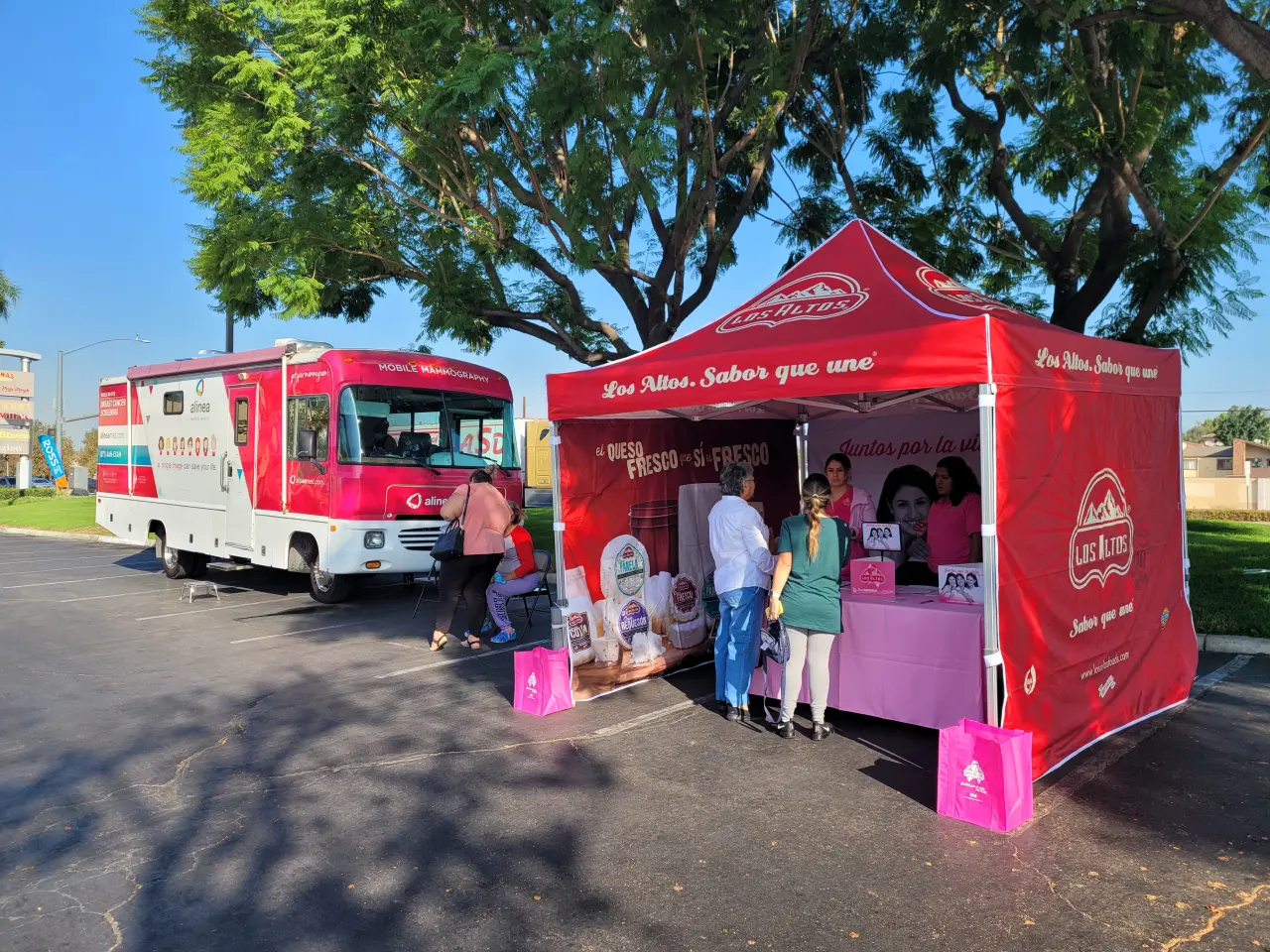 Los Altos branded heavy duty 10x10 pop up tent next to a mobile unit during a breast cancer awareness campaign event.