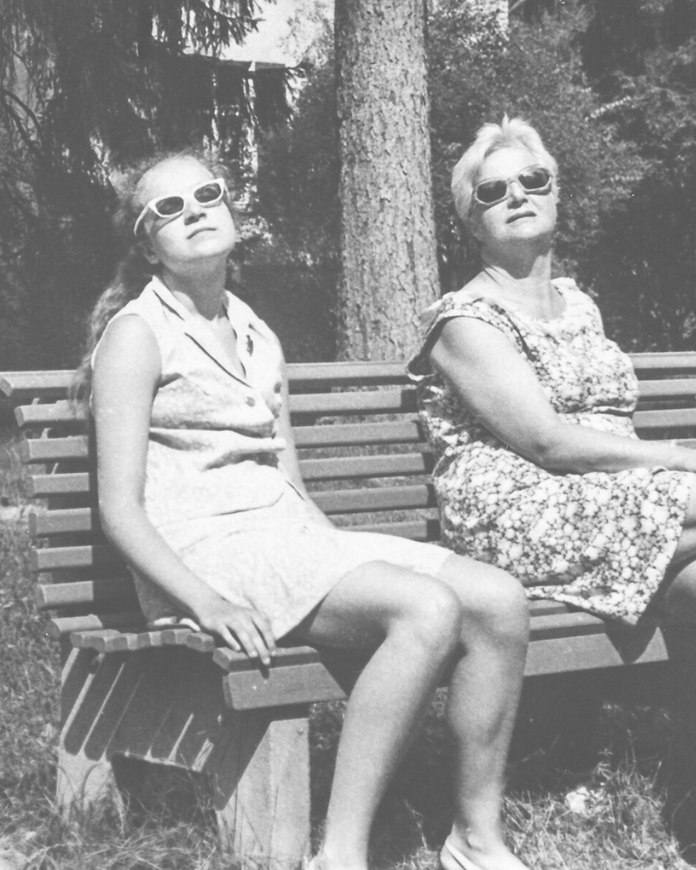 Black and white retro photo of two ladies on a bench