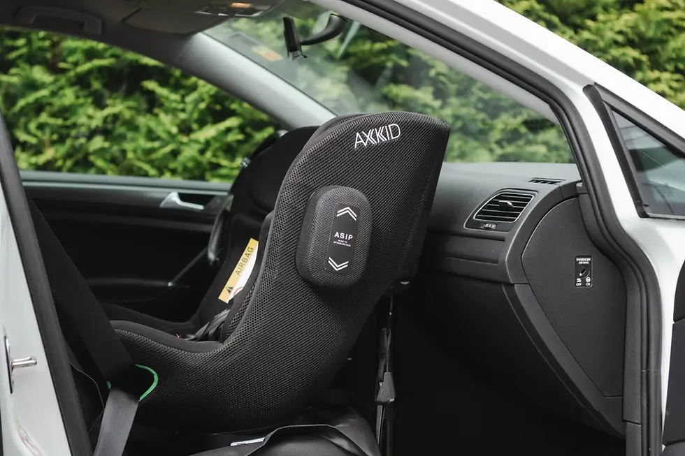 Axkid MoveKid safely installed rear-facing in the front seat