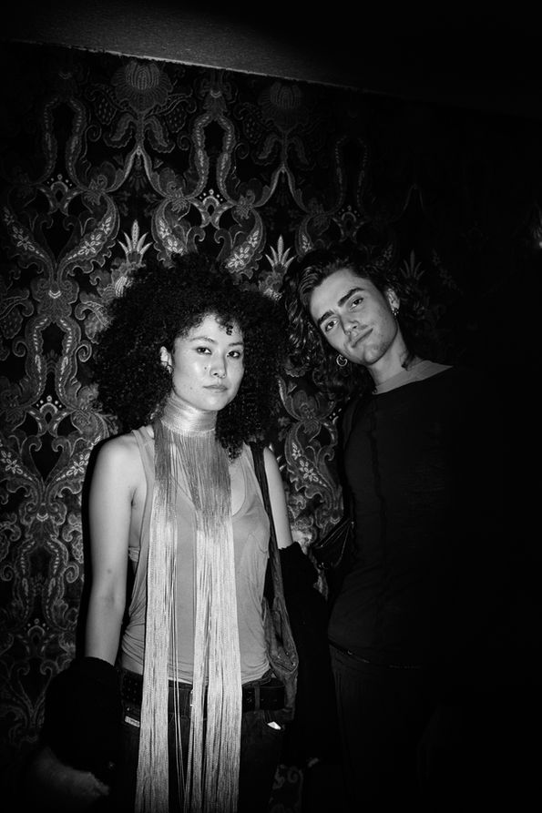 Atmospheric portrait in Tokyo, expression both strange and tender, framed against textured wall — nearlism