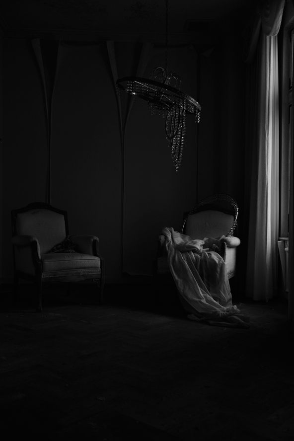 A room where curtains no longer move, still air sealing time — nearlism photography