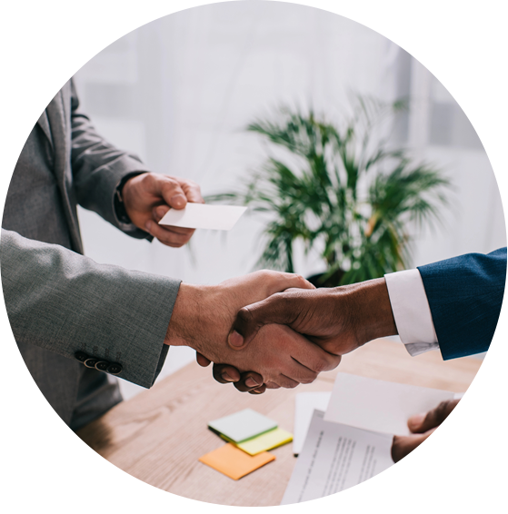Businessmen shaking hands, exchanging business cards