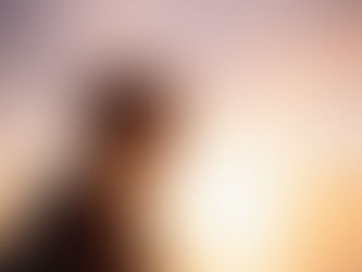 young adult looking out at a sunset
