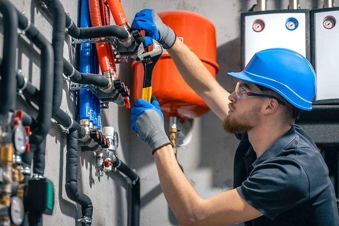 man-installs-heating-system-house-checks-pipes-with-wrench (1).jpg