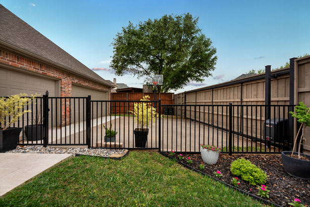 Modern metal and iron privacy fence design for a luxury home in Prosper.