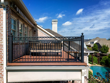 Professional custom deck build with integrated iron safety railings in Lewisville.
