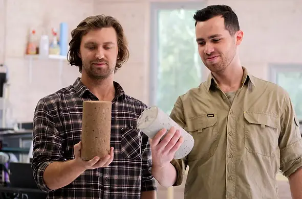 Ramon Skane and Hendrik Gildenhuys, co-founders of the Colliecrete Project and Reformix, holding samples of geopolymer concrete made from industry by-products sourced from the Collie region.