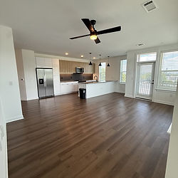 Clean, empty modern apartment with hardwood floors.